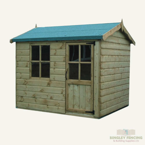 The Hobbit Kids Playhouse by Bingley Fencing, constructed with child-friendly preservatives, features a charming blue roof. It includes a window on the left side and a wooden door with a window panel on the right. This delightful structure can effortlessly serve as the kind of enchanting playhouse kids love, nestled in a tranquil setting.