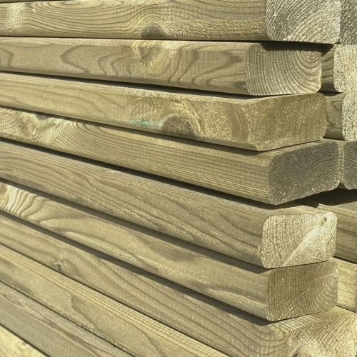 stack of  horizontal timbers with a smooth finish in a timber yard for use in fence panel construction. Known as battens