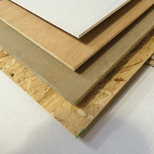 A stack of various Bingley Fencing's Sheet Material FSC OSB3 sheets, showcasing a range of colors and textures, is elegantly arranged on a plain white surface. The bottom sheet highlights a distinctive wood chipboard pattern.