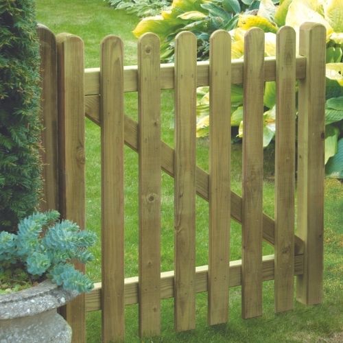 picket gate with rounded wooden palings in a garden